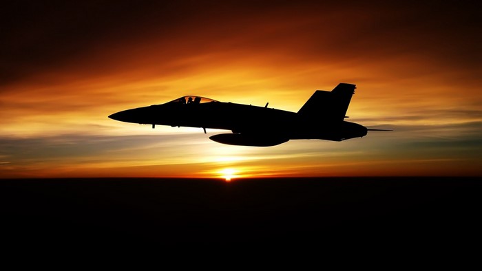 Silhouette of a McDonnell Douglas F/A-18 Hornet at sunset