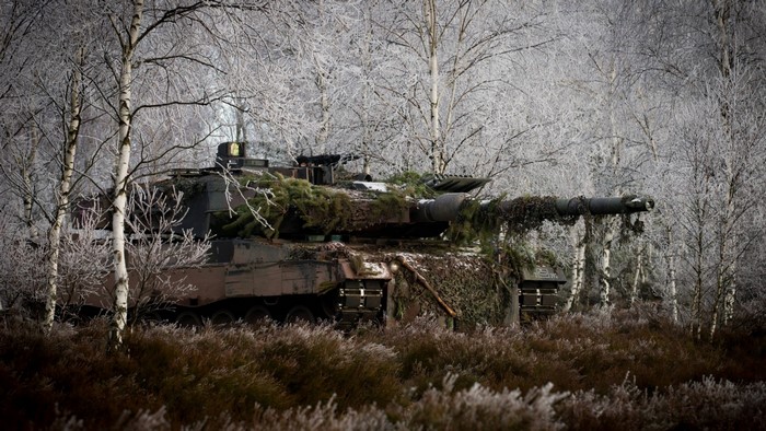 Leopard 2 tank camouflaged in a winter forest
