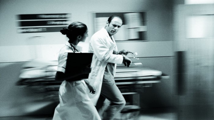 Doctors running in a hospital hallway