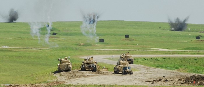 Military training exercise with Bradley Fighting Vehicles and explosions