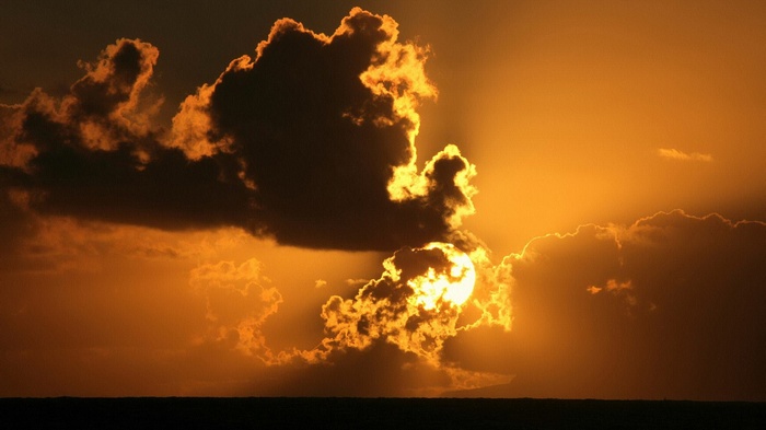 Sunset with dramatic clouds over the ocean