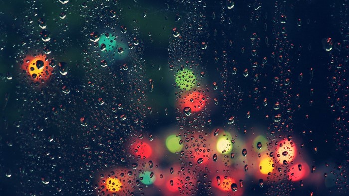 Raindrops on glass with bokeh lights