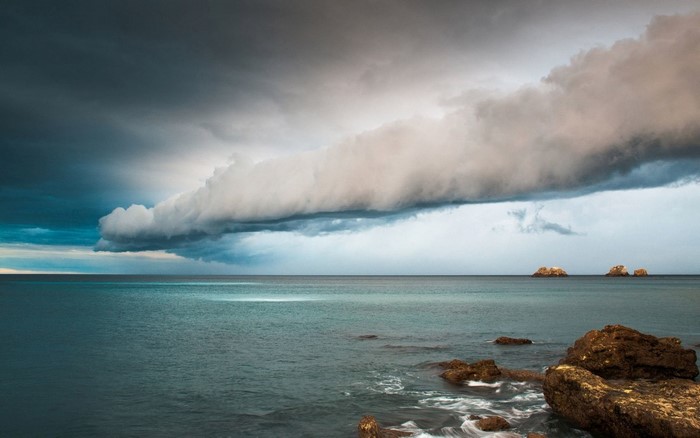 Stormy clouds over the sea with rocks