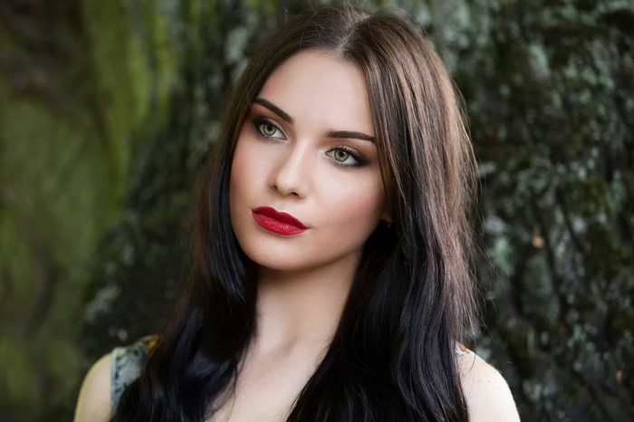 Woman with long dark hair and red lipstick