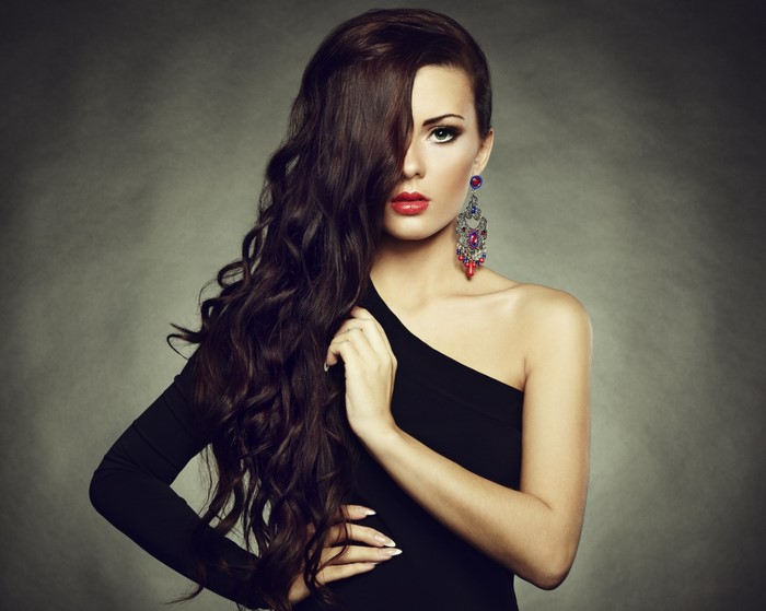 Woman with long dark hair and elaborate earring