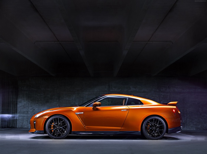 Orange Nissan GT-R parked in a dark garage