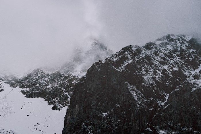 Snow-covered mountains shrouded in mist