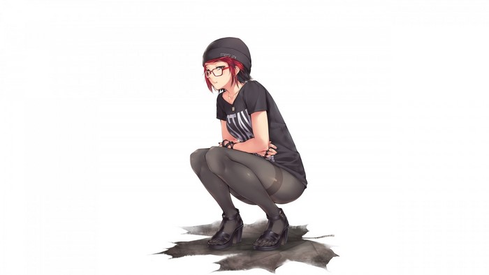 Redhead girl with glasses and beanie crouching