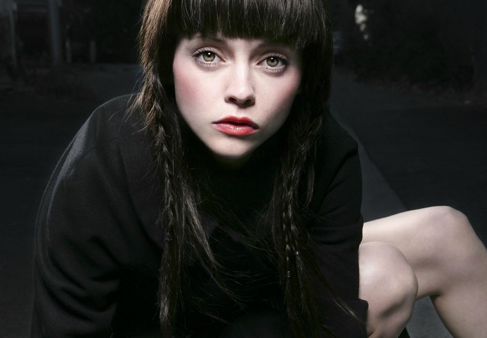 Christina Ricci in a black top with braided hair