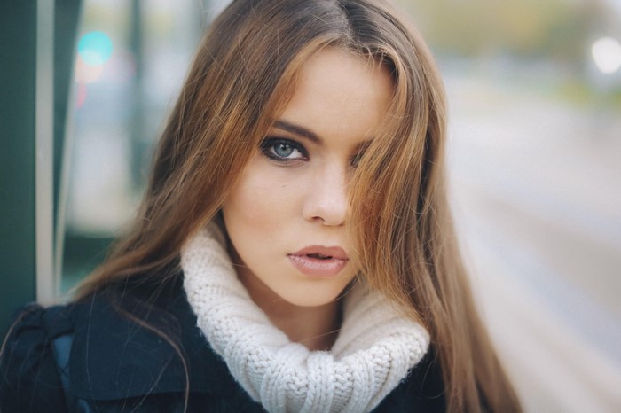 Woman with long brown hair wearing a turtleneck