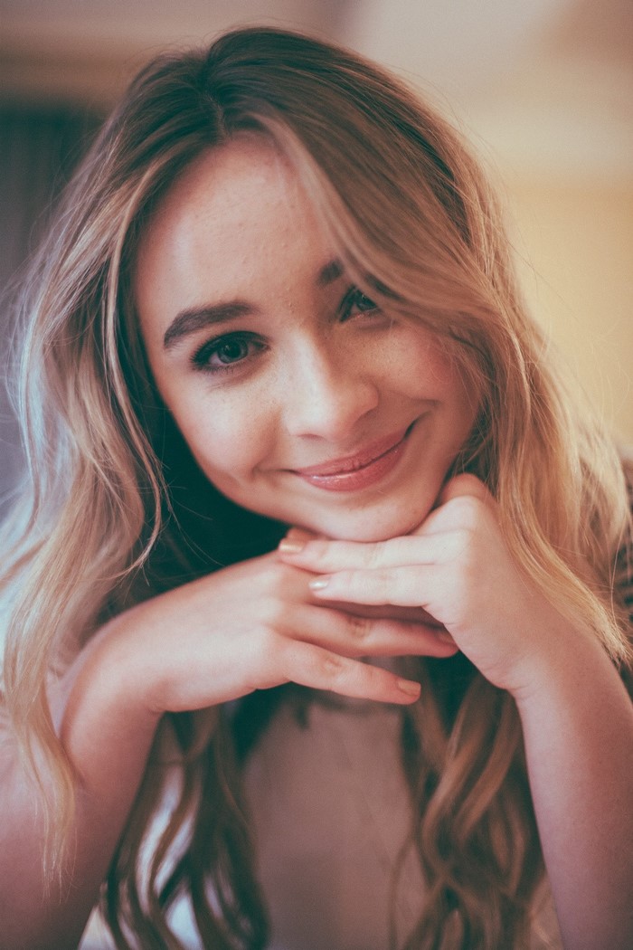 Sabrina Carpenter portrait with hands on chin