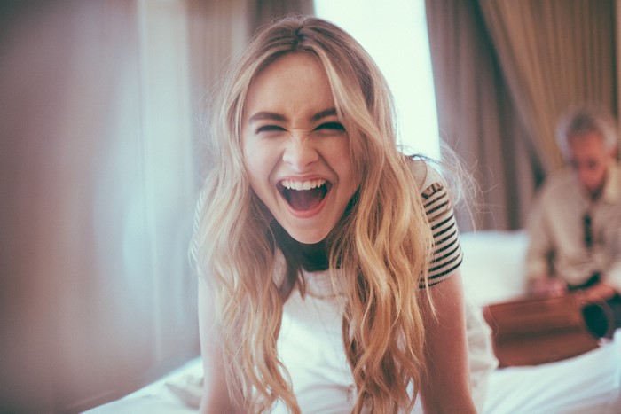 Joyful Blonde Woman Laughing with Long Hair