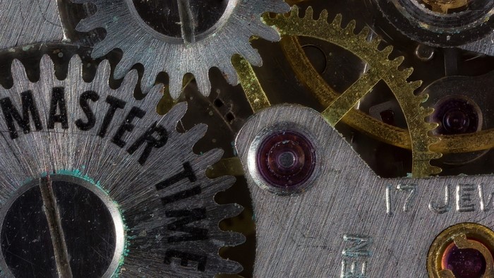 Close-up of watch gears with text 'MASTER TIME' and '17 JEWELS'