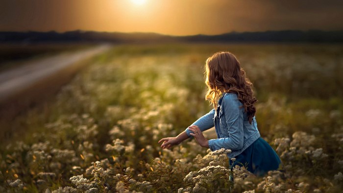 Woman in a field at sunset