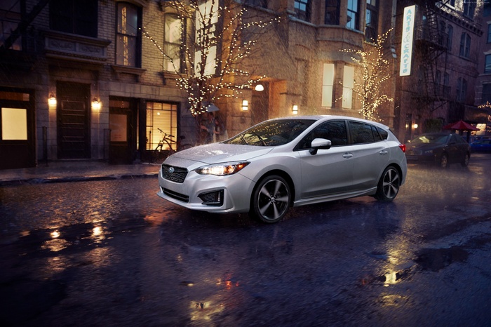 Silver Subaru Impreza 5-door sport on wet city street