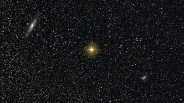 Andromeda Galaxy and a bright star in space
