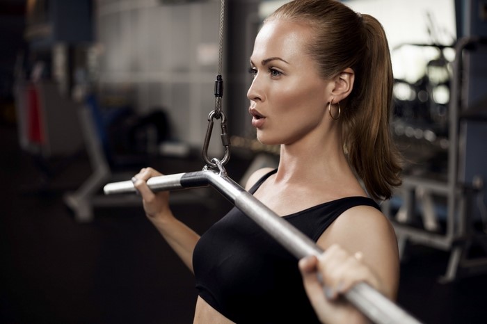 Woman Exercising with Lat Pulldown Machine