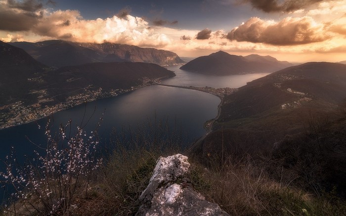 Lake and mountains at sunset with clouds
