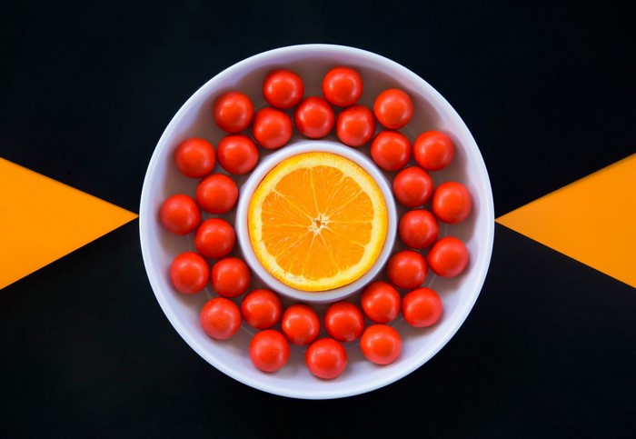 Orange slice and cherry tomatoes in a bowl