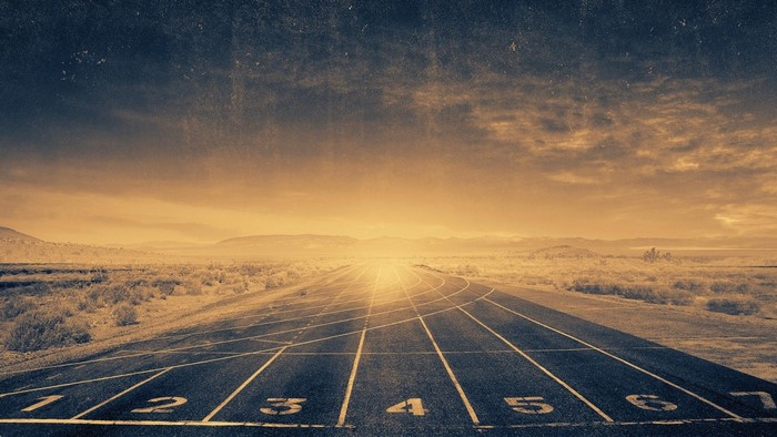 Running track in a desert landscape at sunset