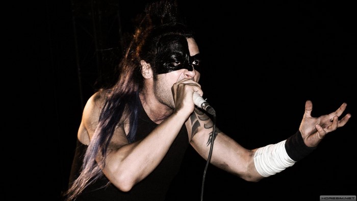 Hayko Cepkin performing on stage with a microphone