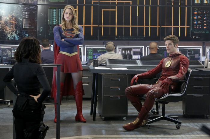 Supergirl and The Flash in a control room