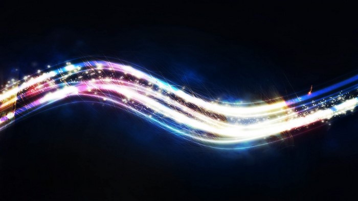 Abstract light waves with sparkles on a dark background
