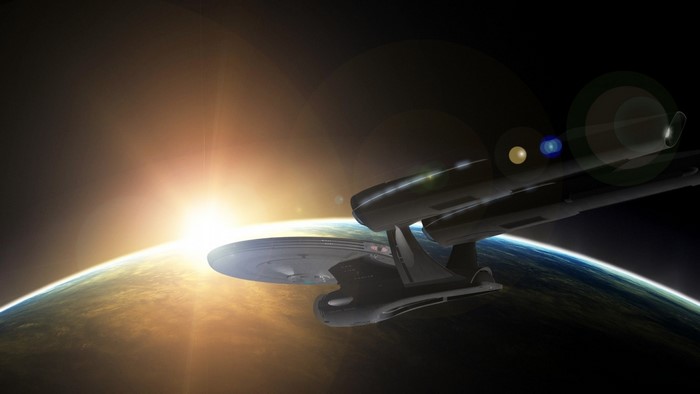 Star Trek USS Enterprise spaceship orbiting Earth at sunrise