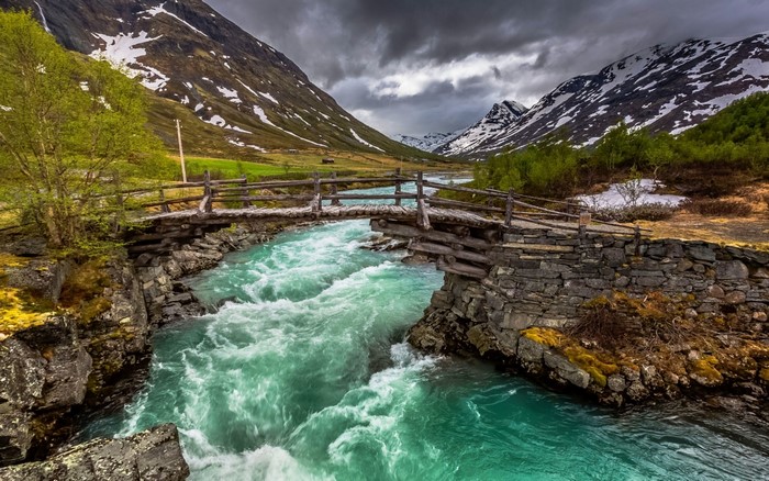 Rustic Bridge Over Turquoise River in Norwegian Valley