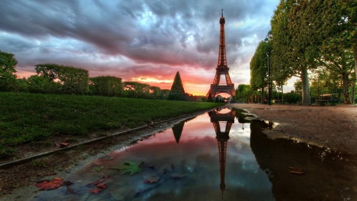 Eiffel Tower reflection in puddle at sunset