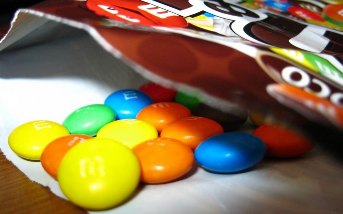 M&M's candies spilling out of a bag