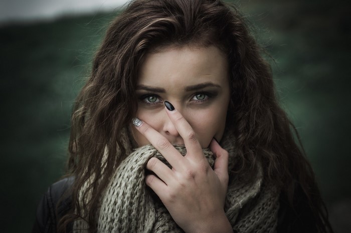 Woman with green eyes and scarf looking at viewer