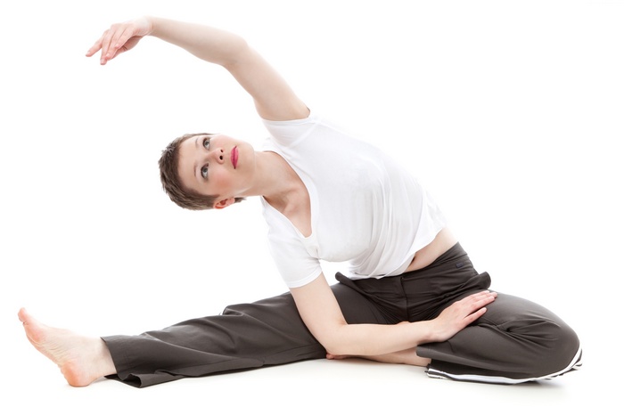 Woman stretching on a white background