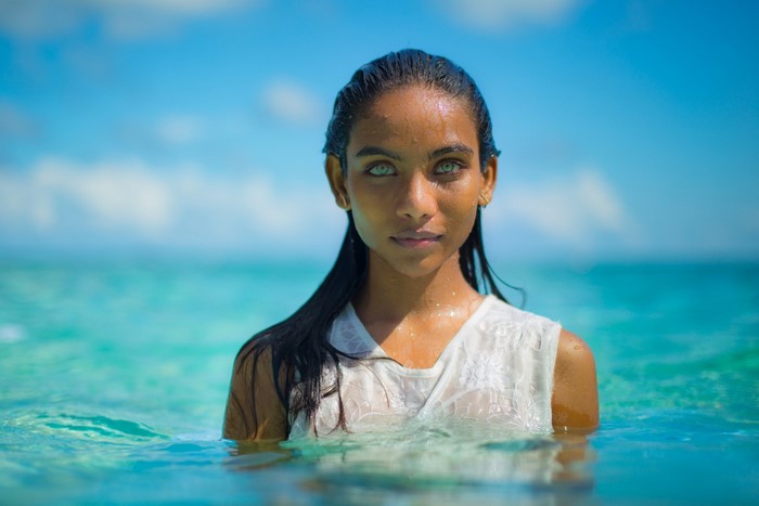 Woman with striking blue eyes in the ocean