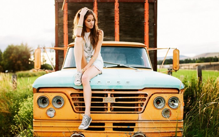 Woman sitting on a vintage Dodge truck