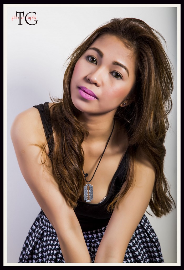 Woman with long brown hair and pink lipstick