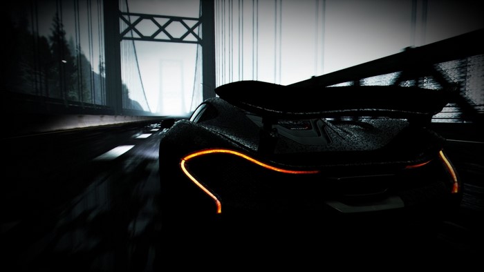 Black McLaren P1 sports car on a bridge at night