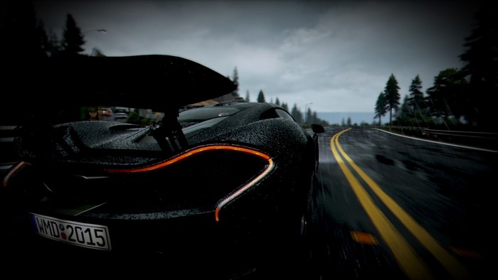 Black McLaren P1 driving on a wet road at night