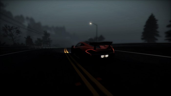McLaren P1 driving on a foggy road at night