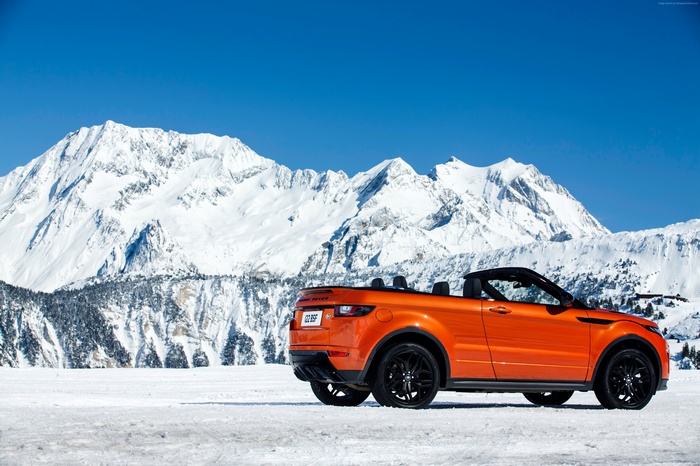 Orange Range Rover Evoque Convertible in Snowy Mountains