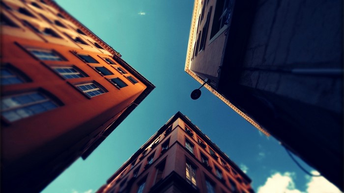 Buildings viewed from below against a blue sky