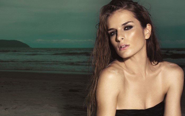 Woman with smoky eyes on a beach