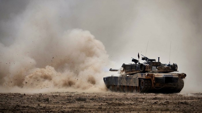 M1 Abrams tank in dust cloud