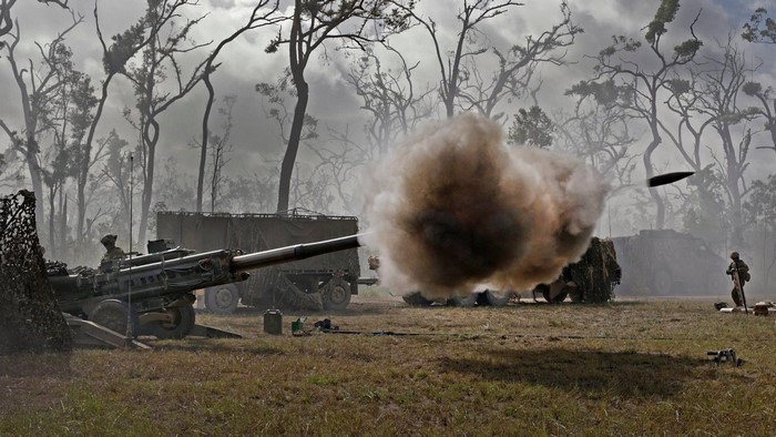 Australian Army M777 howitzer firing in a forest