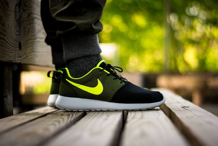 Nike Roshe Run sneakers on wooden bench
