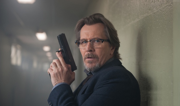 Gary Oldman holding a gun