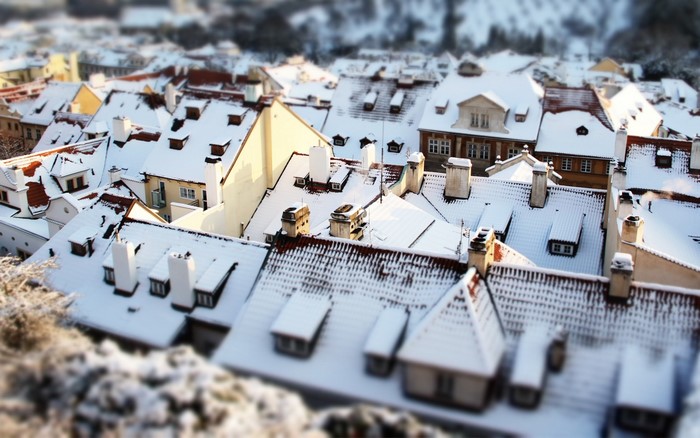 Snow-covered rooftops in a European city during winter