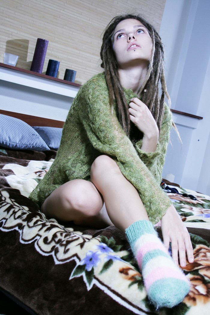 Model Sindi S with dreadlocks wearing a green sweater
