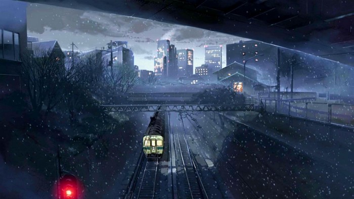 Train in a snowy city at night