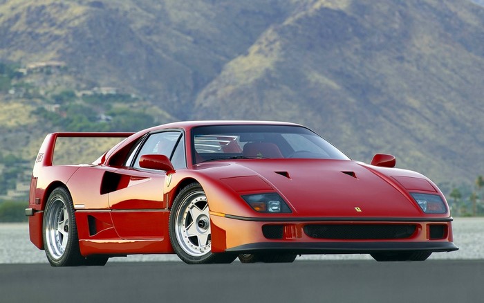 Red Ferrari F40 Supercar Against Mountain Backdrop